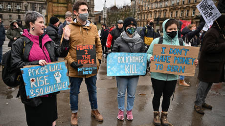 Protesters are shown demonstrating against the UK's rising costs for energy and other necessities last February in Glasgow.