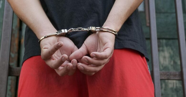 Photo by Kindel Media: https://www.pexels.com/photo/a-person-in-black-shirt-wearing-handcuffs-7785099/