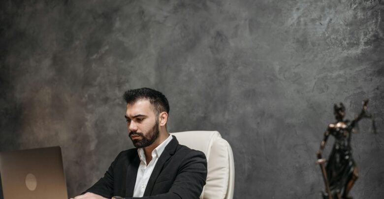 Photo by Pavel Danilyuk: https://www.pexels.com/photo/a-man-in-black-suit-sitting-on-chair-8112118/